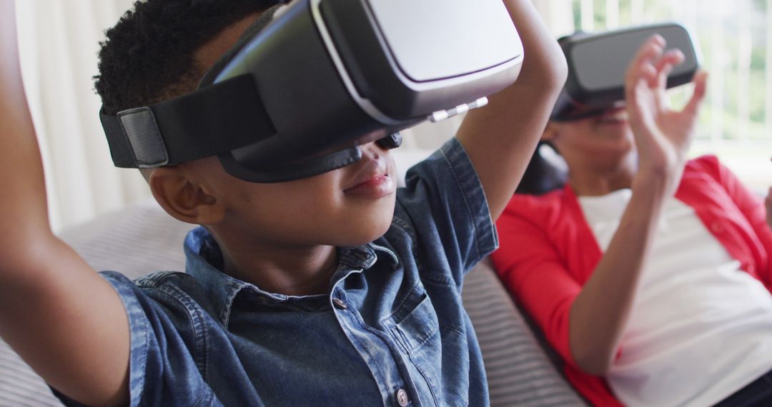 Children Immersed in Virtual Reality Gaming at Home Relaxing on Couch - Free Images, Stock Photos and Pictures on Pikwizard.com