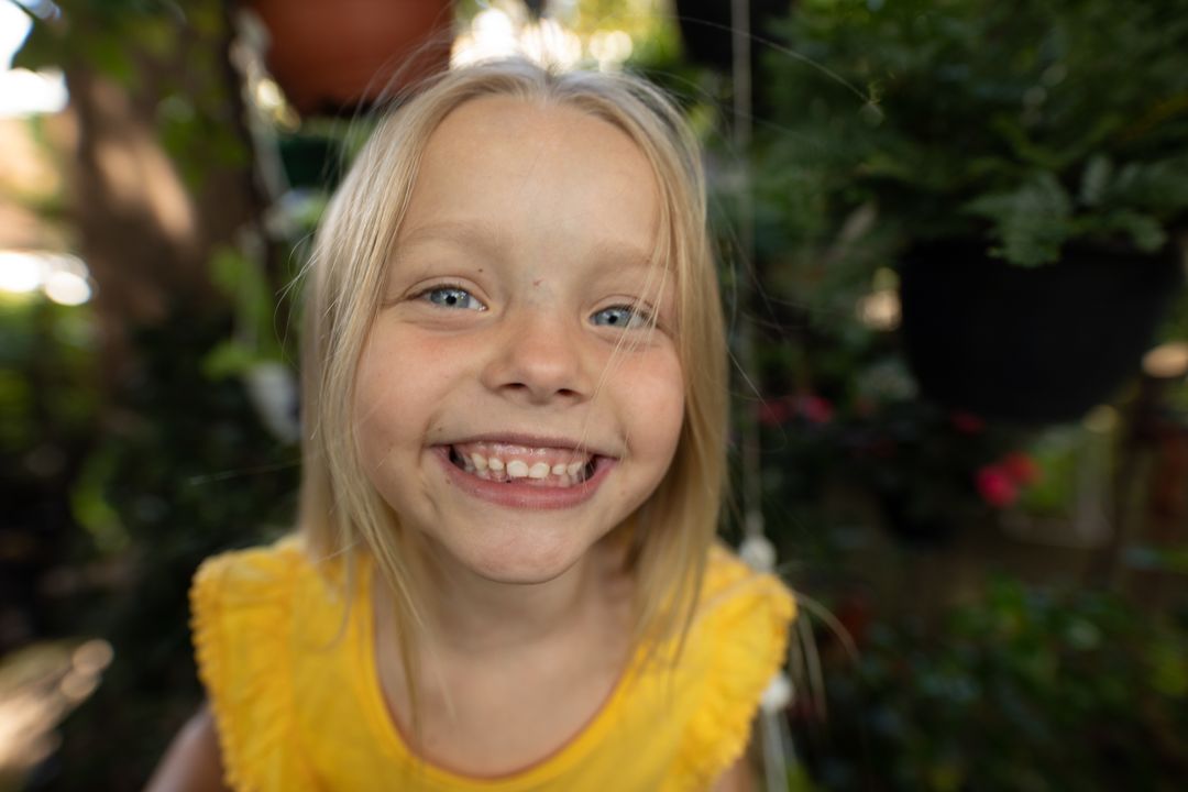 Smiling Blonde Girl Enjoying Sunny Garden - Free Images, Stock Photos and Pictures on Pikwizard.com