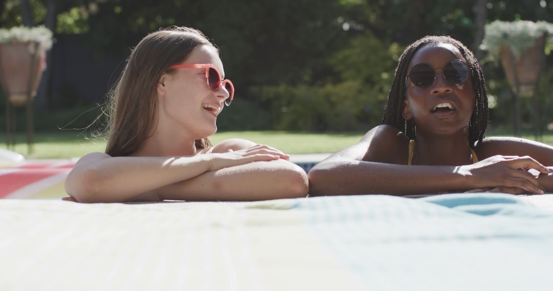 Two Women Relaxing and Enjoying Pool Time Together - Free Images, Stock Photos and Pictures on Pikwizard.com