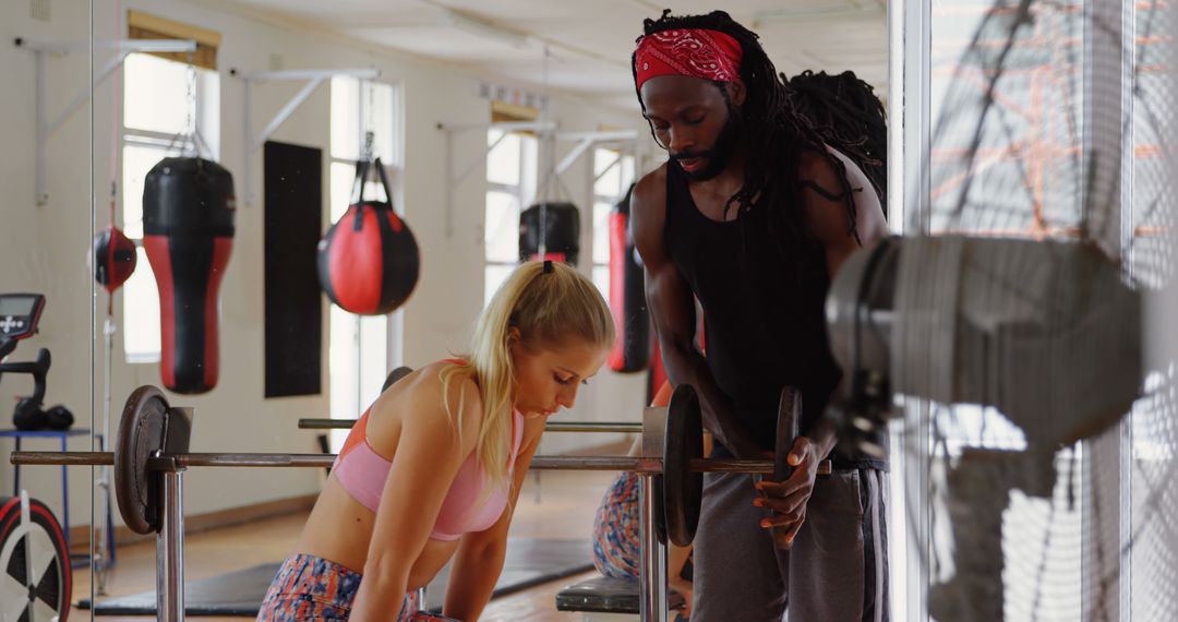 Personal Trainer Assisting Woman with Barbell Workout in Gym - Free Images, Stock Photos and Pictures on Pikwizard.com