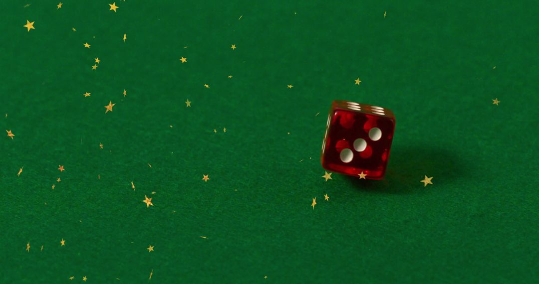 Red Dice Amid Sparkling Stars on Green Surface