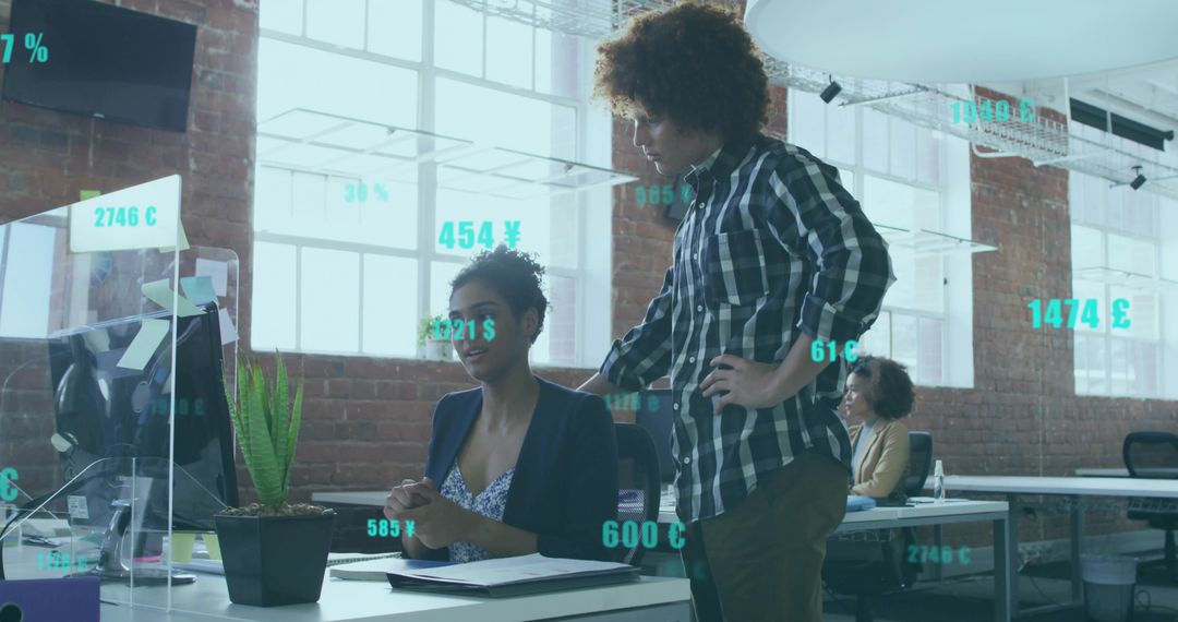 Reviewing augmented reality financial data, collaborating in modern loft workspace