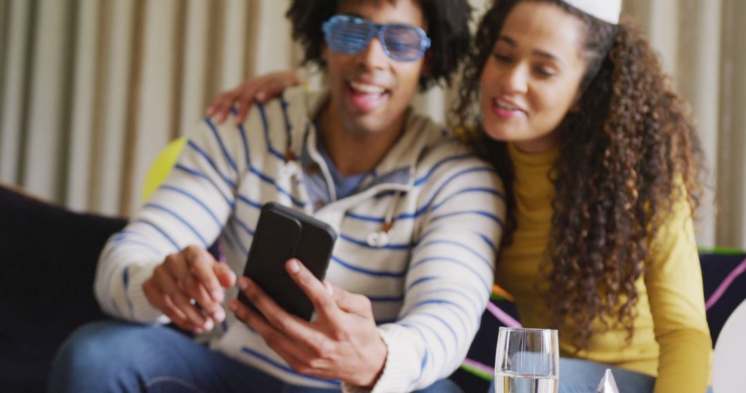 Image of happy diverse couple celebrating new years eve and making image call on smartphone at home - Free Images, Stock Photos and Pictures on Pikwizard.com