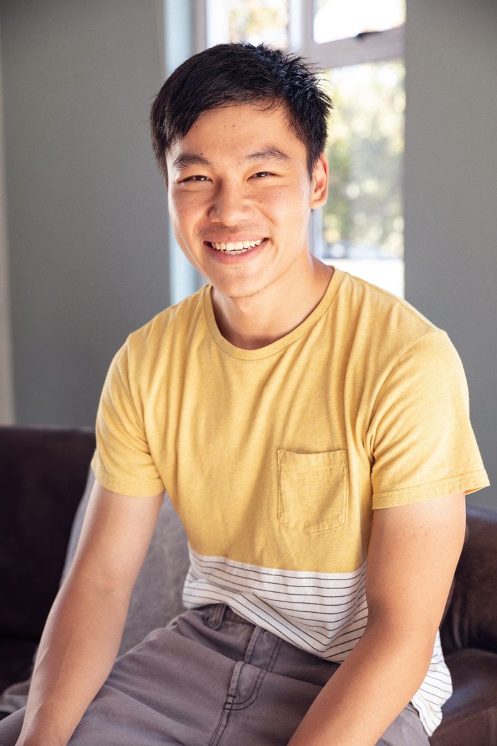 Casual Young Man Relaxing on Sofa at Home