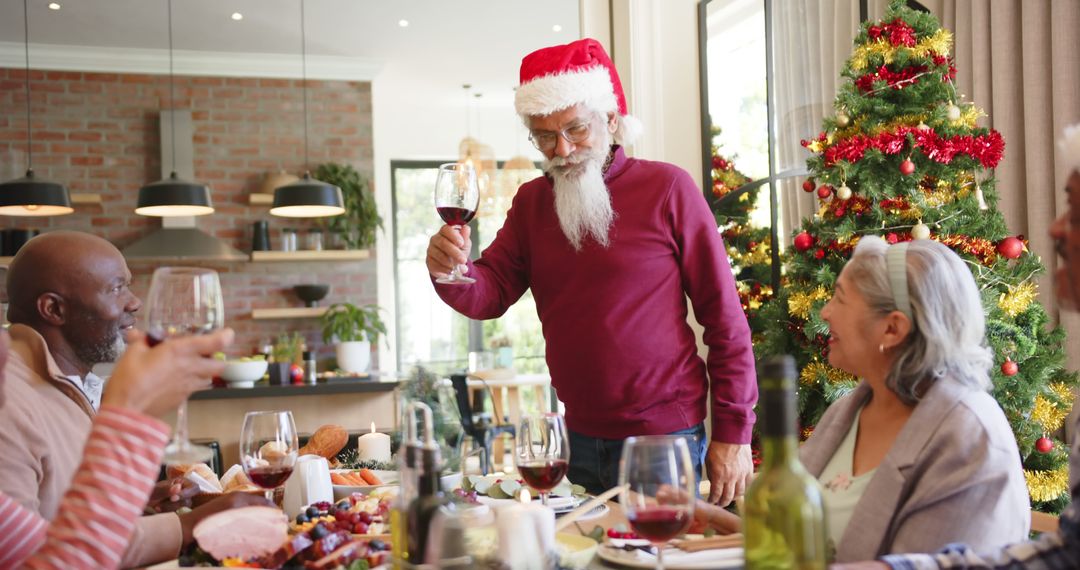 Happy Senior Man Toasting at Festive Family Christmas Dinner - Free Images, Stock Photos and Pictures on Pikwizard.com