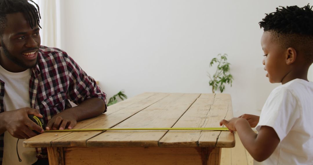 Father and Son Measuring Wooden Table with Tape Measure at Home - Free Images, Stock Photos and Pictures on Pikwizard.com