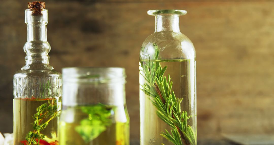 Assortment of Infused Olive Oils in Glass Bottles with Fresh Herbs - Free Images, Stock Photos and Pictures on Pikwizard.com