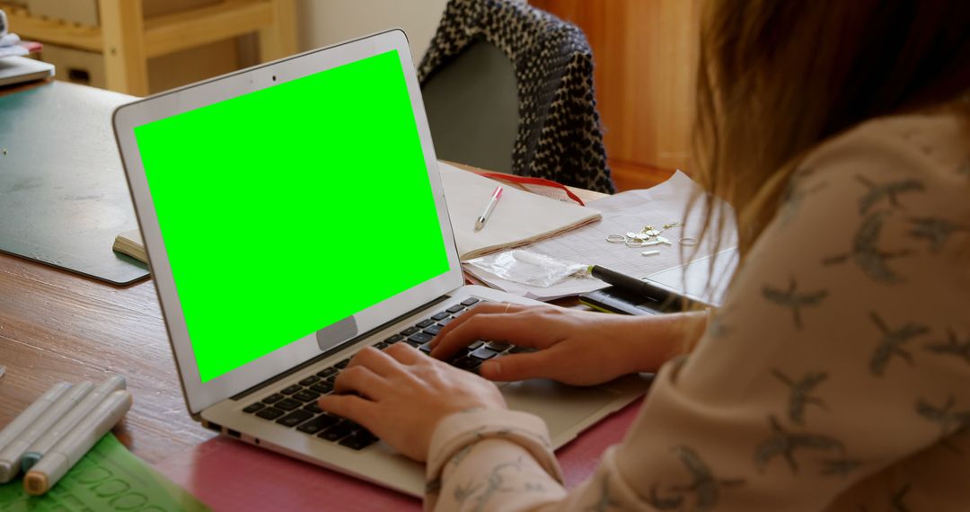 Woman Using Laptop with Green Screen at Desk - Free Images, Stock Photos and Pictures on Pikwizard.com