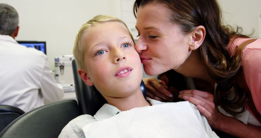 Mother Kissing Son on Cheek During Dental Checkup - Free Images, Stock Photos and Pictures on Pikwizard.com