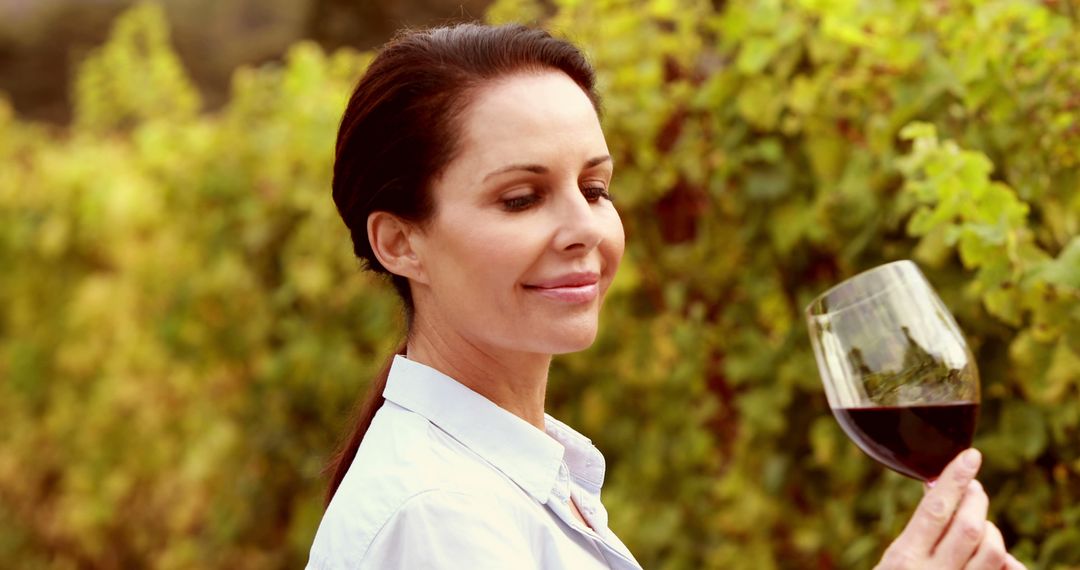 Woman Enjoying Glass of Red Wine in Vineyard - Free Images, Stock Photos and Pictures on Pikwizard.com