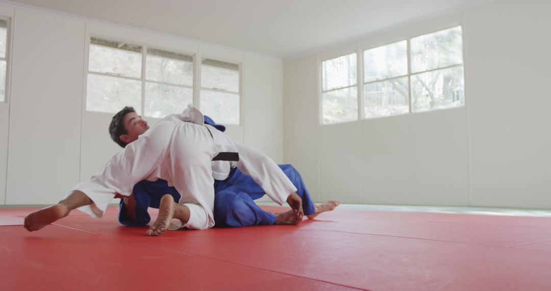 Young Men Practicing Judo Techniques in Training Facility - Free Images, Stock Photos and Pictures on Pikwizard.com