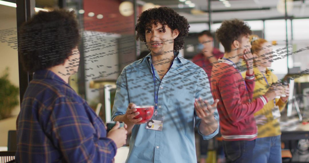 Curly-haired man presenting ideas during collaborative brainstorming in open modern office