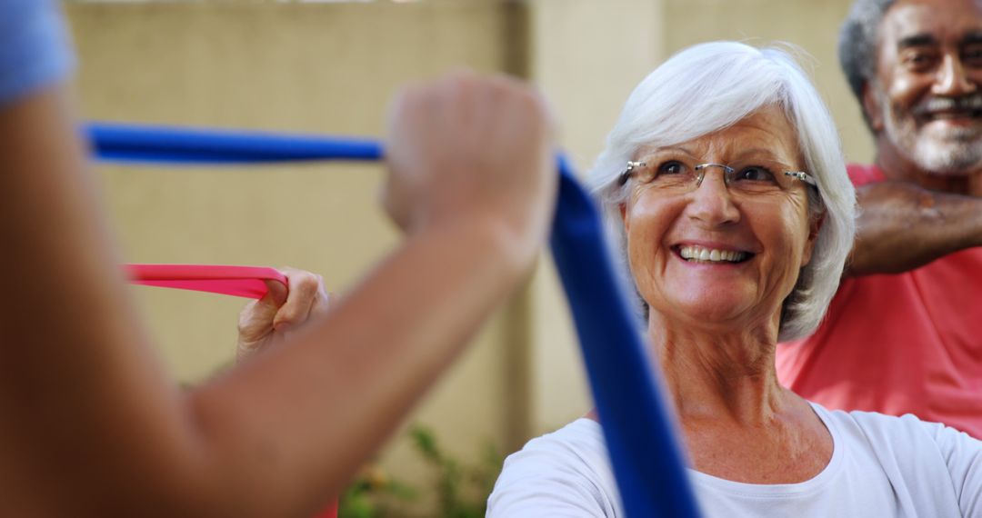 Active Senior Citizens Exercising with Exercise Bands Outdoors - Free Images, Stock Photos and Pictures on Pikwizard.com