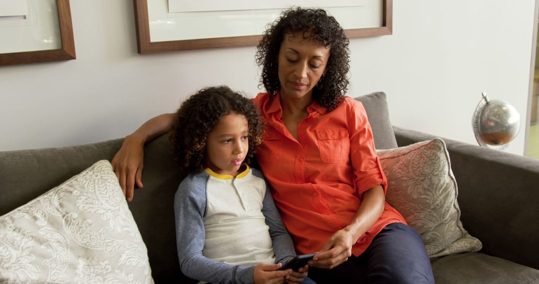 Mother and son bonding on couch with smartphone - Free Images, Stock Photos and Pictures on Pikwizard.com