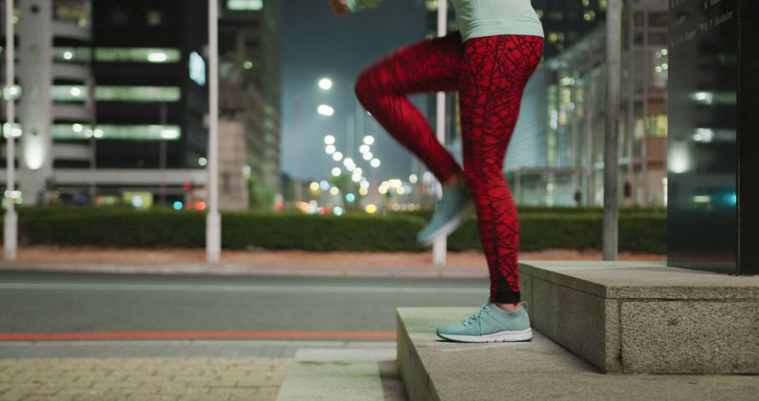 Person Exercising Outdoors at Night in the City Wearing Red Leggings - Free Images, Stock Photos and Pictures on Pikwizard.com