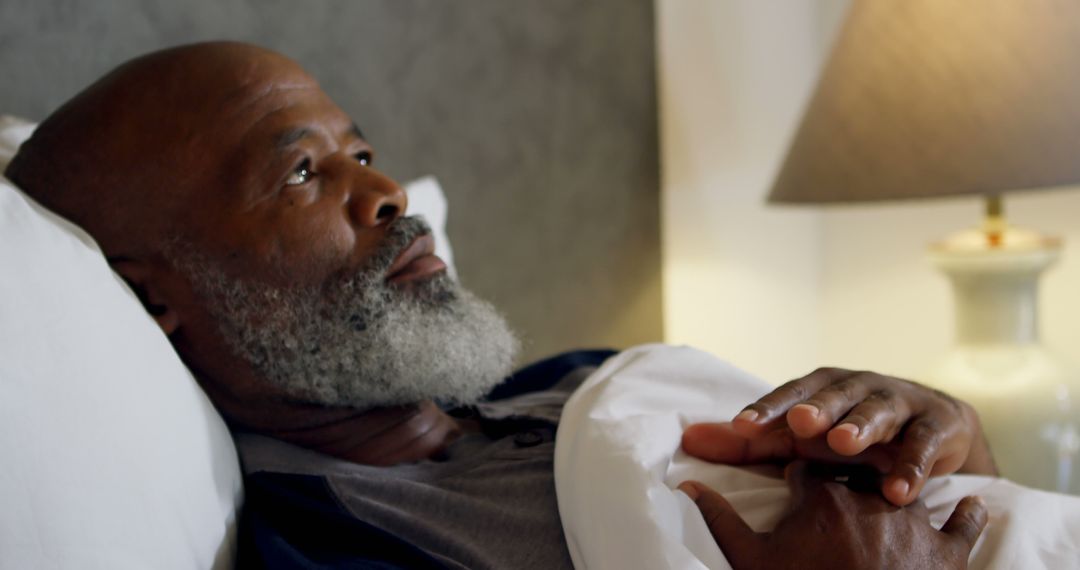 Elderly man reflecting while lying in bed, thinking quietly - Free Images, Stock Photos and Pictures on Pikwizard.com