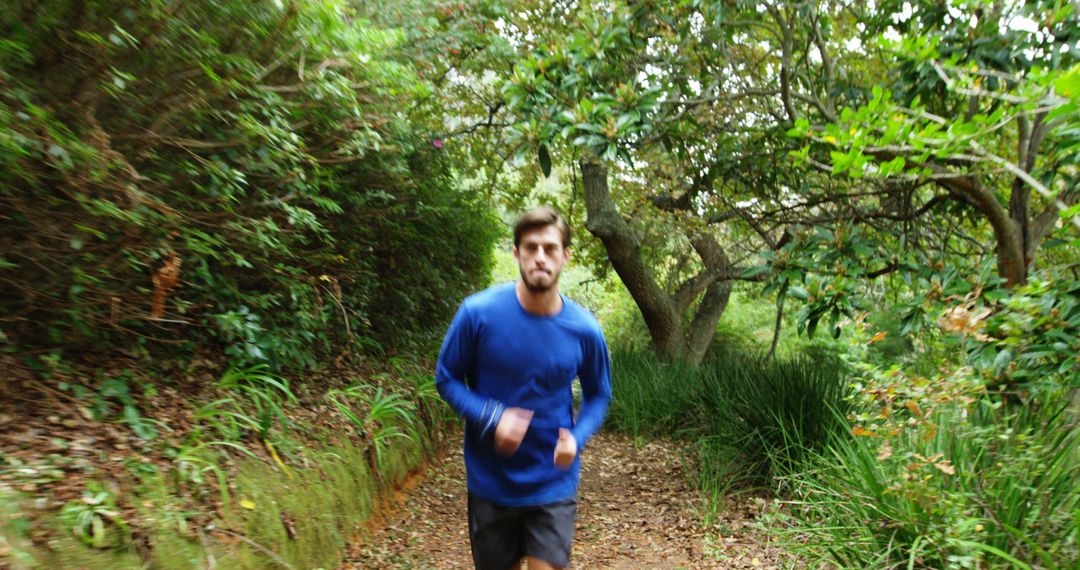 Man Jogging on Forest Trail in Blue Long Sleeved Shirt - Free Images, Stock Photos and Pictures on Pikwizard.com