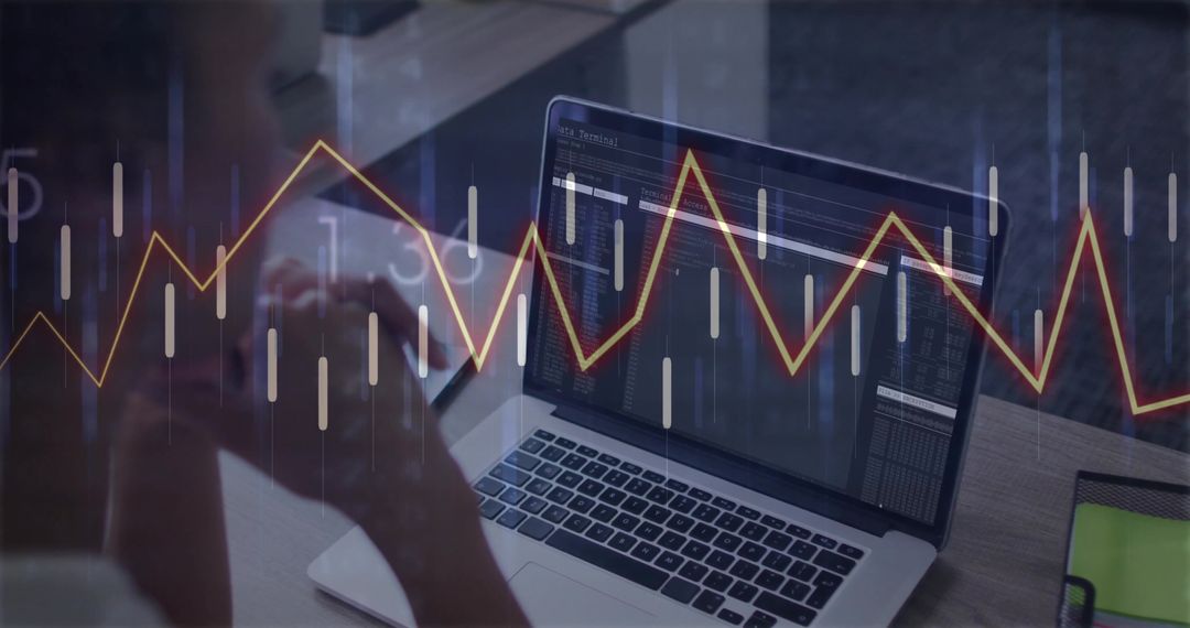Woman Analyzing Graph on Laptop for Financial Insights in Office