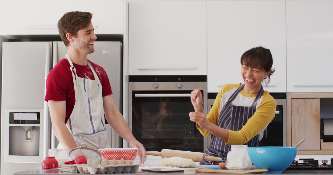 Image of happy diverse couple baking together in kitchen - Free Images, Stock Photos and Pictures on Pikwizard.com