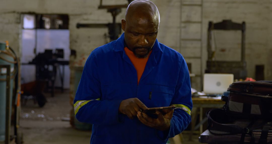 Male Industrial Worker Using Tablet in Workshop - Free Images, Stock Photos and Pictures on Pikwizard.com