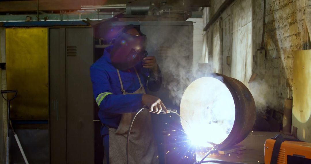 Welder in Industrial Workshop Working on Metal Pipe with Sparks - Free Images, Stock Photos and Pictures on Pikwizard.com