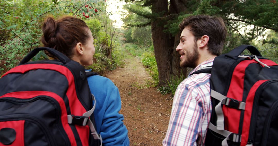 Young Couple Hiking and Conversing in Tranquil Forest Scenery