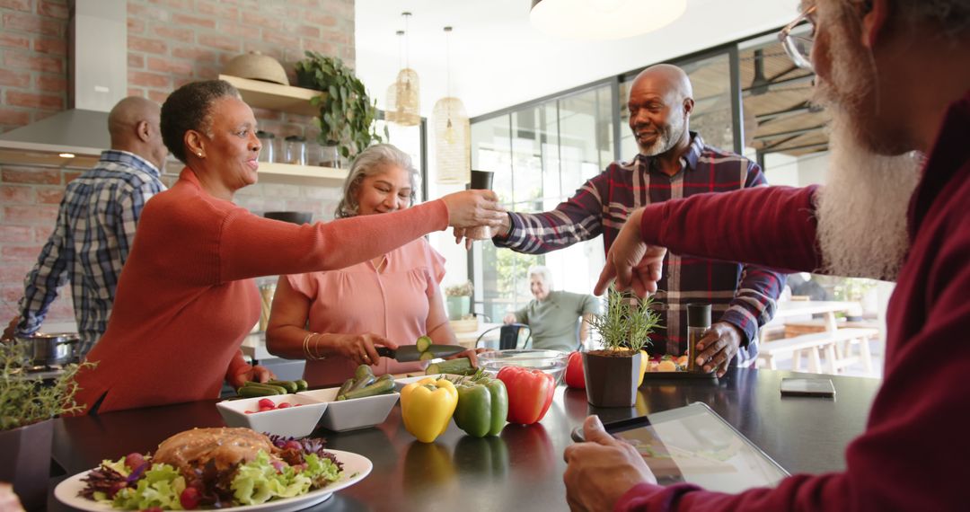 Diverse Group of Seniors Enjoying Meal Prep and Toasting in Modern Kitchen - Free Images, Stock Photos and Pictures on Pikwizard.com