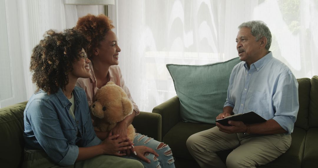 African American multigenerational family having calm conversation on green sofa at home