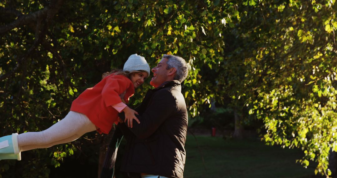 Father Joyfully Lifted Daughter in Forest at Sunset - Free Images, Stock Photos and Pictures on Pikwizard.com