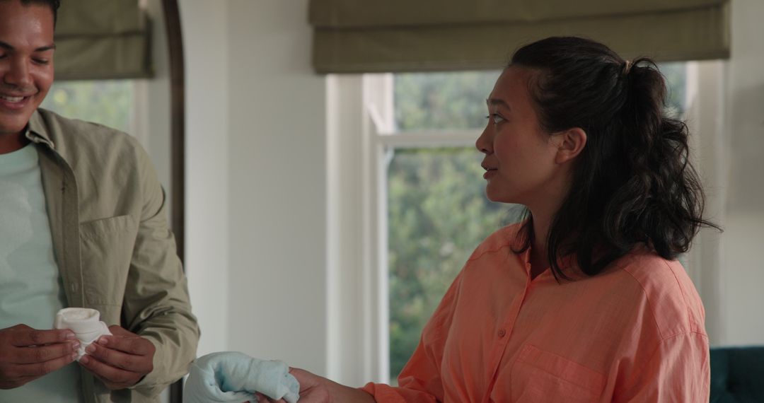 Couple Embracing Pregnancy Journey at Home in Relaxation