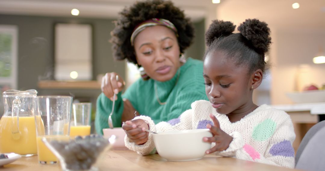 African American Mother and Daughter Enjoy Breakfast Together at Home - Free Images, Stock Photos and Pictures on Pikwizard.com