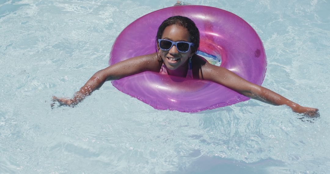 Happy Girl Enjoying Pool Fun with Purple Float in Summer - Free Images, Stock Photos and Pictures on Pikwizard.com