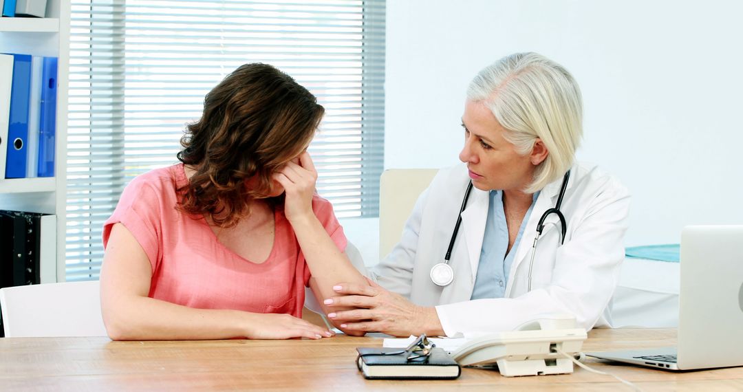 Compassionate Doctor Consulting Distressed Patient in Medical Office - Free Images, Stock Photos and Pictures on Pikwizard.com