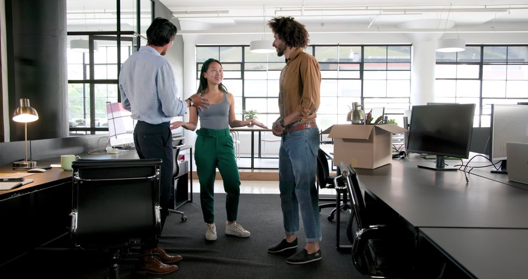 Diverse Team Collaborating While Unpacking in Modern Office Space