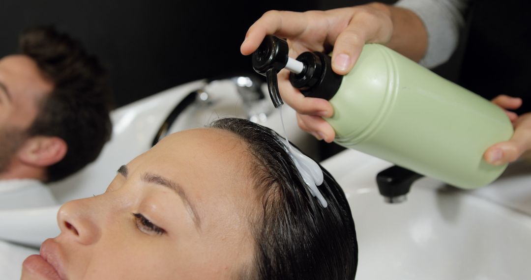 Hairdresser Applying Shampoo to Woman's Wet Hair in Salon - Free Images, Stock Photos and Pictures on Pikwizard.com