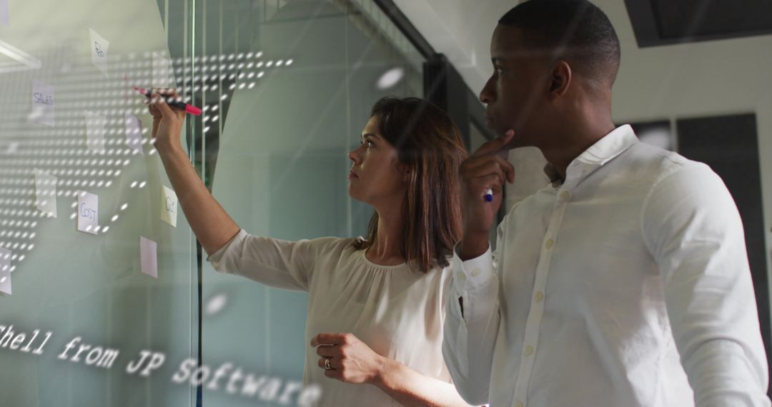 Team Collaborating with Digital Overlay on Glass Wall
