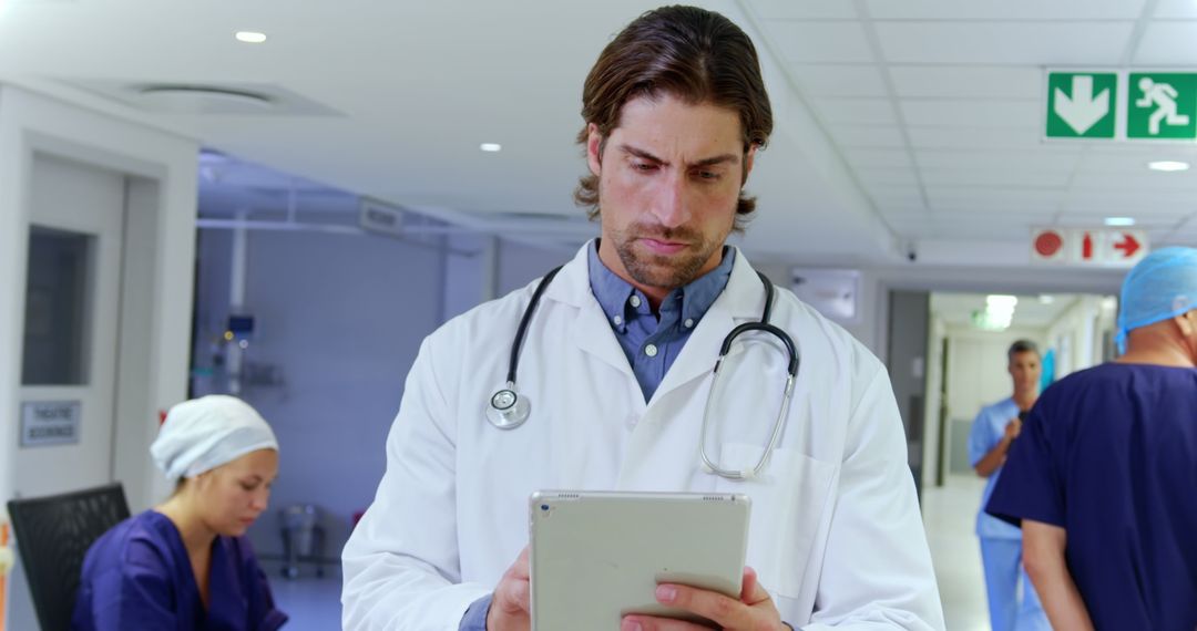 Doctor Using Tablet for Patient Information in Hospital - Free Images, Stock Photos and Pictures on Pikwizard.com