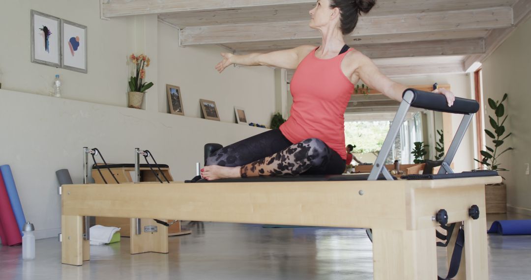 Woman Practicing Pilates on Reformer - Free Images, Stock Photos and Pictures on Pikwizard.com