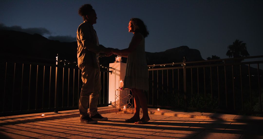Romantic Nighttime Proposal Illuminated by Candlelight