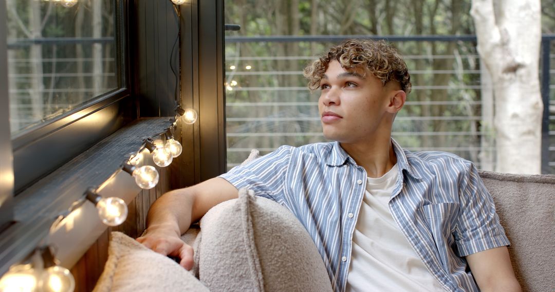 Calm Man Relaxing Near Large Window with Natural Light