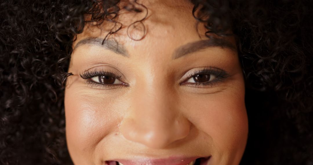 Portrait of Smiling Woman with Curly Hair and Confident Expression