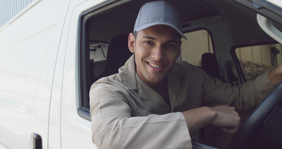 Smiling Delivery Driver Sitting in Vehicle - Free Images, Stock Photos and Pictures on Pikwizard.com