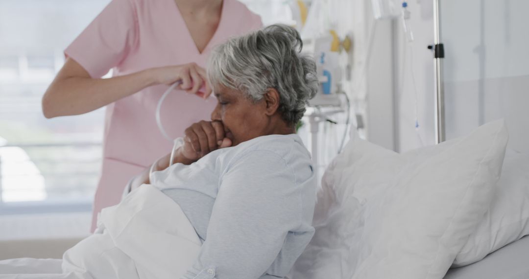 Elderly Woman Receiving Medical Care in Hospital Bed - Free Images, Stock Photos and Pictures on Pikwizard.com