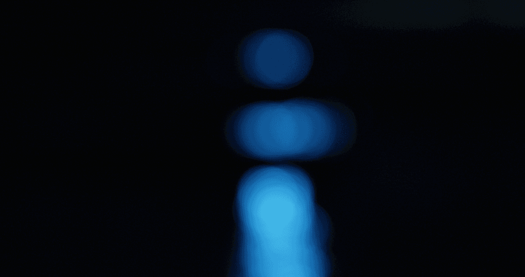 Abstract Defocused Blue Light Rising Behind Horizon