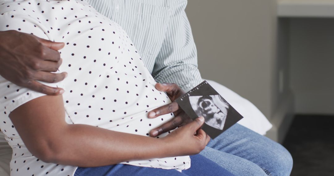 Expectant Couple Embracing Parenthood with Ultrasound Photo