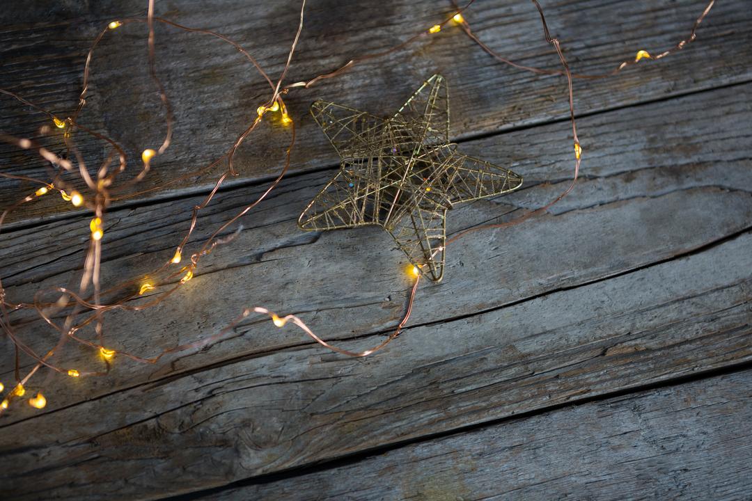 Christmas Star and Fairy Lights on Rustic Wooden Plank - Free Images, Stock Photos and Pictures on Pikwizard.com