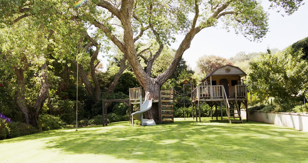 Treehouse with Slide in Lush Green Backyard