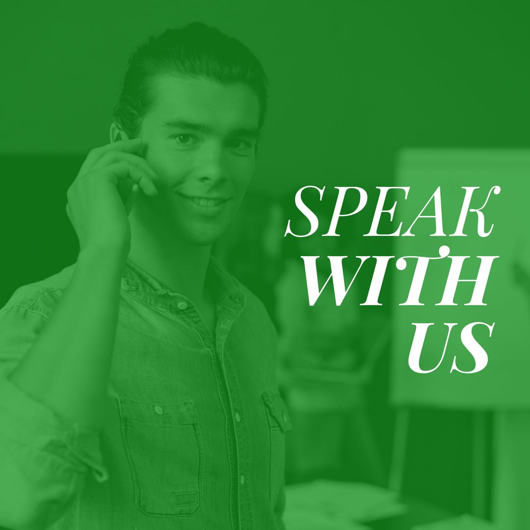 Young Male Counselor Smiling While Talking on Smartphone in Office