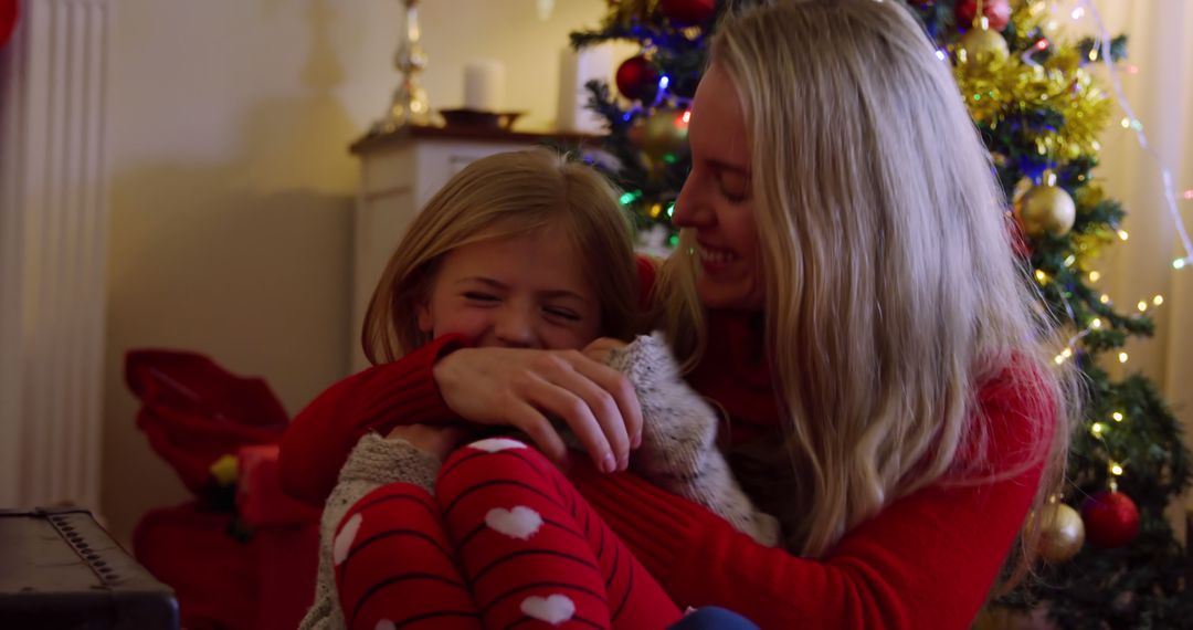 Mother Hugging Daughter During Christmas Celebration - Free Images, Stock Photos and Pictures on Pikwizard.com