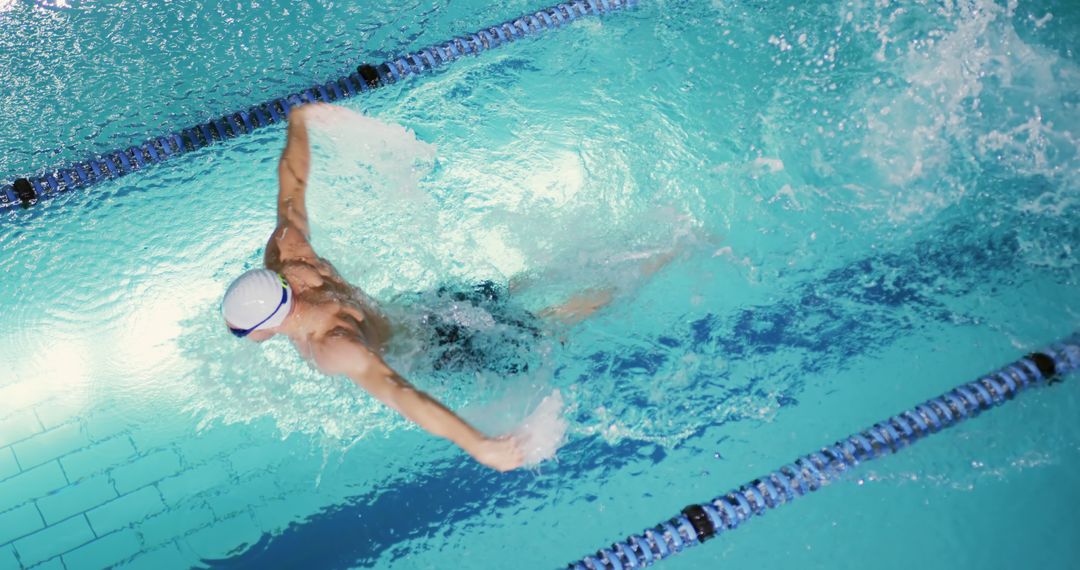 Professional Swimmer Performing Butterfly Stroke in Pool - Free Images, Stock Photos and Pictures on Pikwizard.com